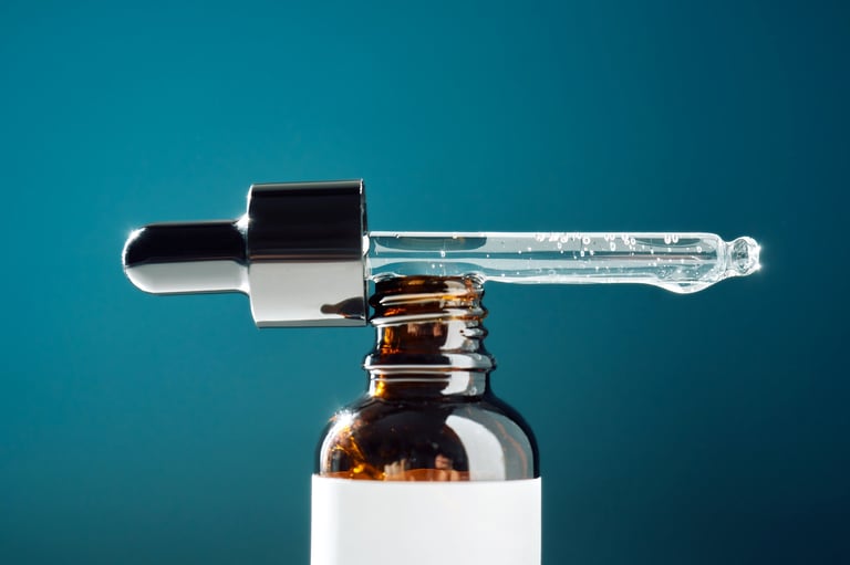 Skincare serum fills a glass pipette, showing liquid texture and bubbles over the amber bottle, representing beauty, health, and cosmetic care